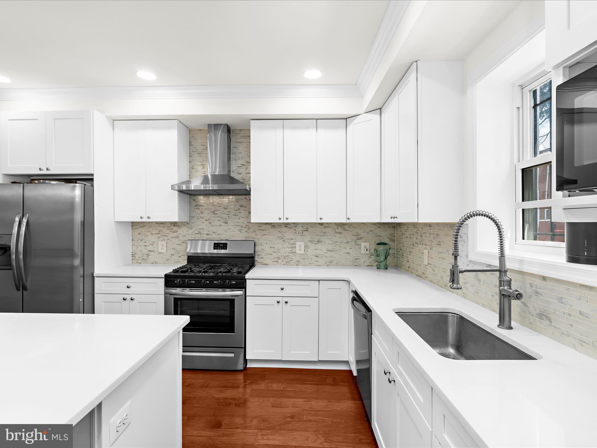 505 Mosher Street Baltimore, MD 21217 - Photo 11 of 46 a kitchen with granite countertop a sink stove and refrigerator