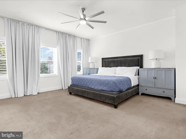 a bedroom with a bed dresser and a window