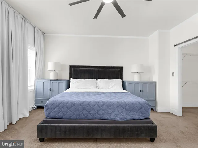 a bedroom with a bed and a night stand