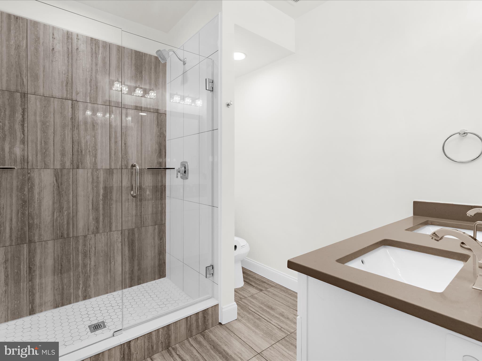 505 Mosher Street Baltimore, MD 21217 - Photo 20 of 46 a bathroom with a sink a toilet and shower