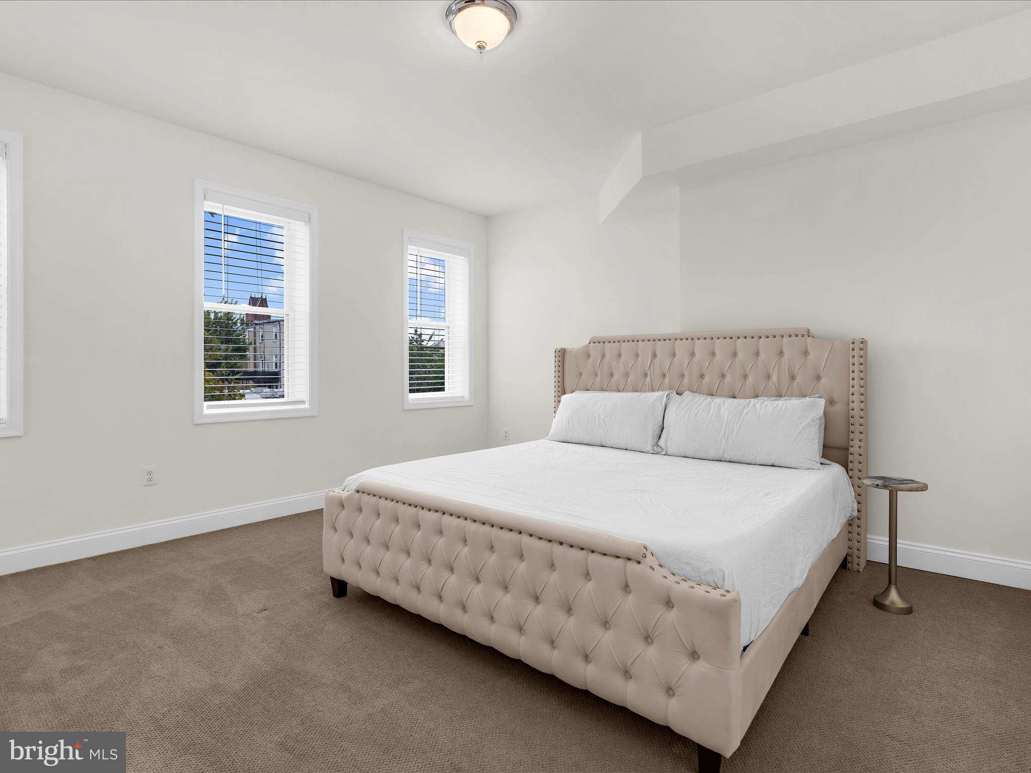 505 Mosher Street Baltimore, MD 21217 - Photo 22 of 46 a large bed sitting in a bedroom next to a window