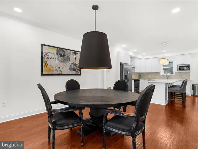 a dining room with furniture and wooden floor