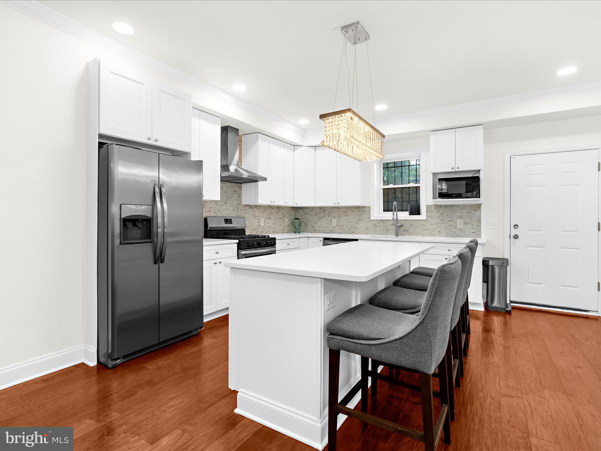 505 Mosher Street Baltimore, MD 21217 - Photo 8 of 46 a kitchen with refrigerator cabinets and wooden floor