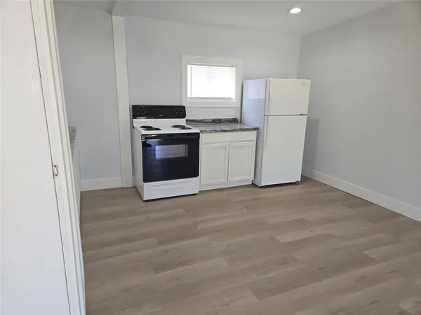 a kitchen with a stove and a refrigerator