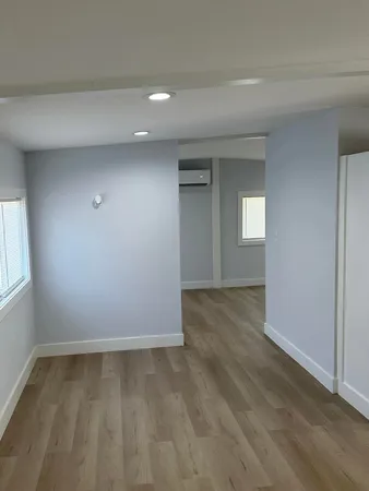 wooden floor and window in an empty room