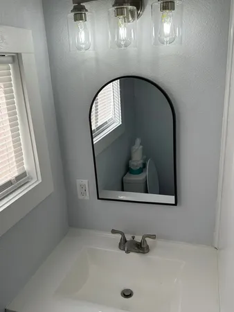 a bathroom with a sink and mirror