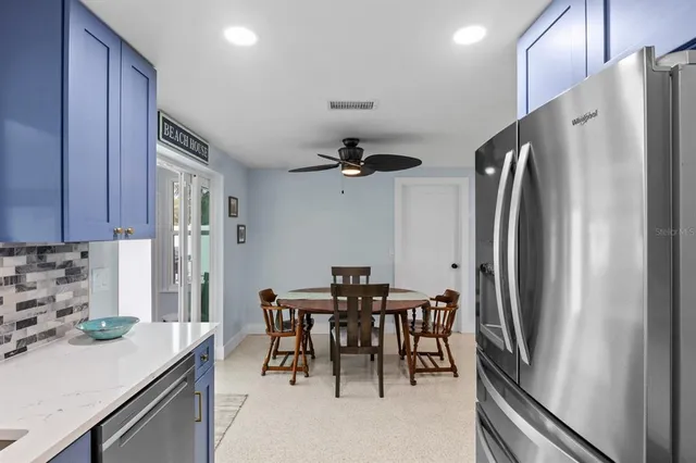a kitchen with stainless steel appliances granite countertop a refrigerator and a sink