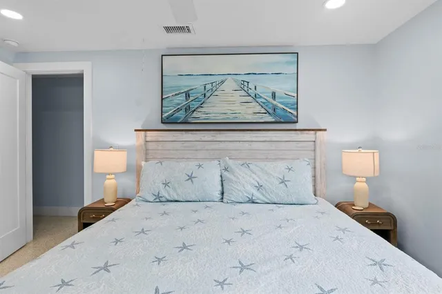 a view of a bedroom with a bed and lamp