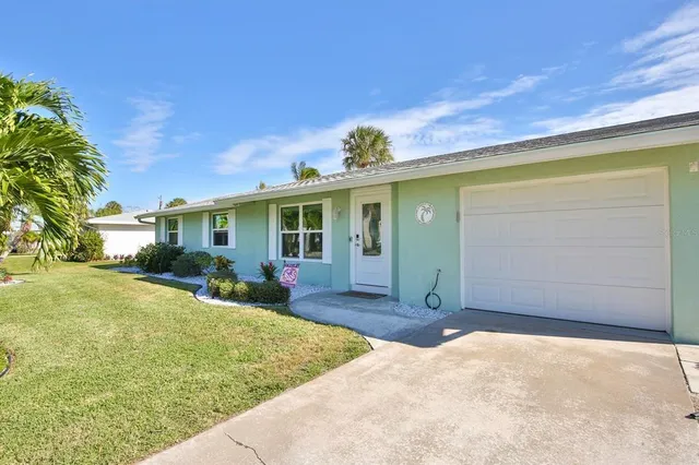 a view of a house with backyard and porch