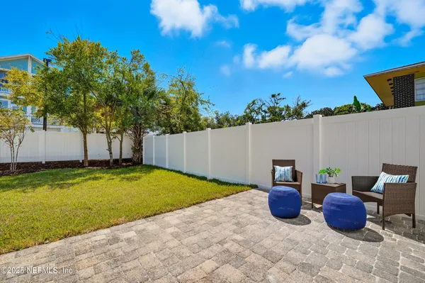 a view of a house with backyard and a tree
