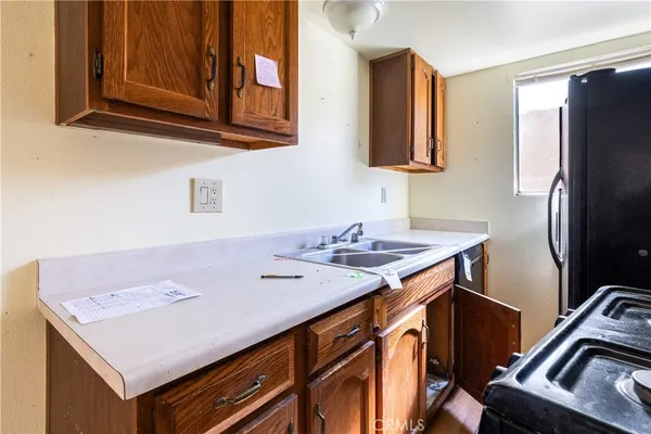 a kitchen with a sink stove and refrigerator
