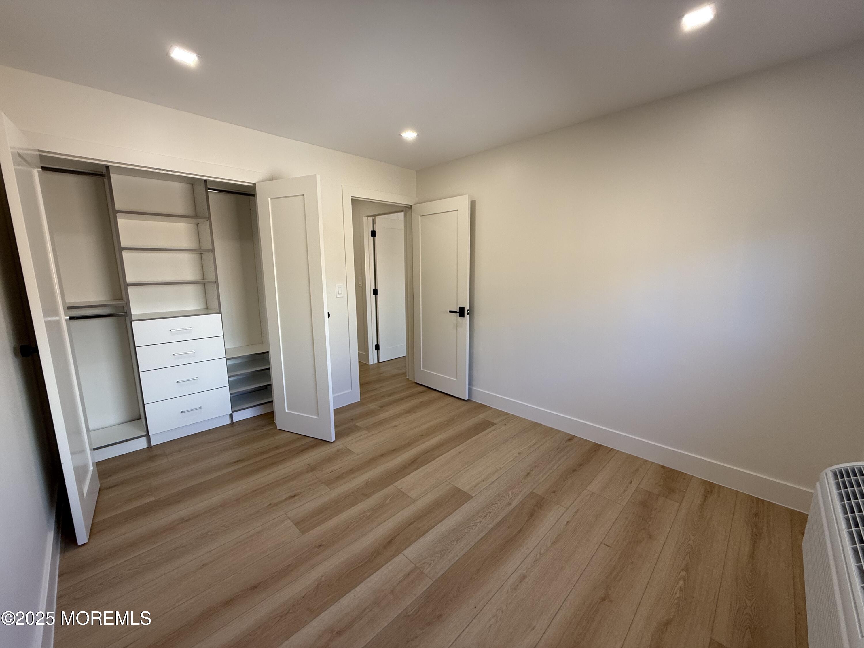1 North Ocean Avenue, Unit 18 Belmar, NJ 07719 - Photo 7 of 10 an empty room with wooden floor and closet