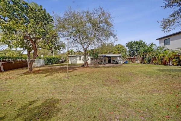 a view of outdoor space with garden and trees