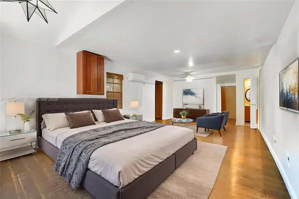 a spacious bedroom with a bed and large windows