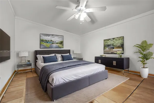 a bedroom with a bed and a chandelier