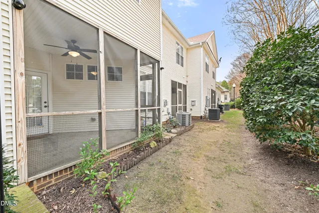 a view of a house with a yard and pathway
