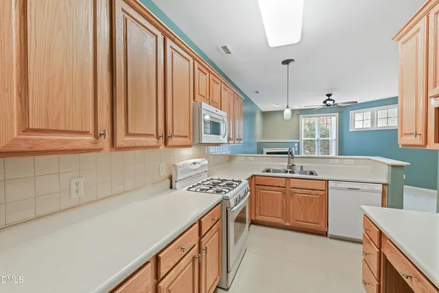 a kitchen that has a sink and a stove in it