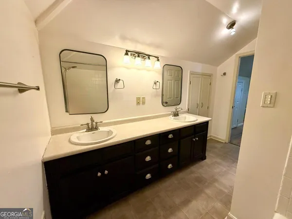 a view of room with wooden floor and tub
