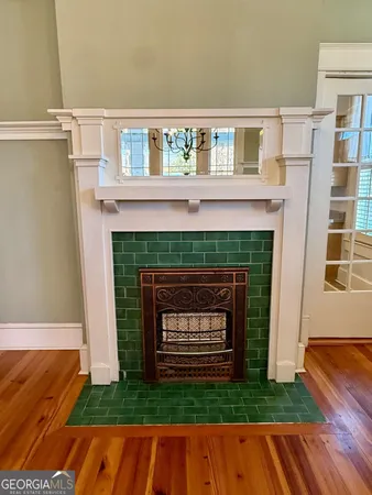 a living room with a fireplace and a floor to ceiling window
