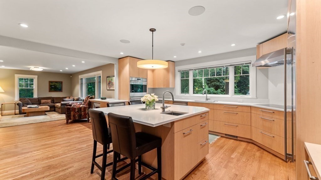 23 Colgate Road Wellesley, MA 02482 - Photo 11 of 32 a dining hall with stainless steel appliances granite countertop a stove a sink a dining table and chairs with wooden floor