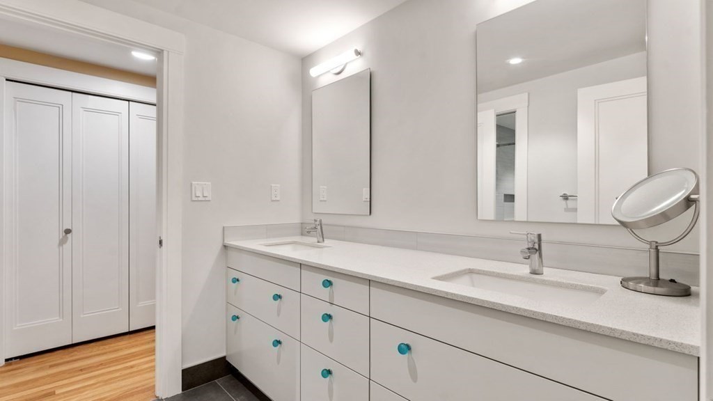 23 Colgate Road Wellesley, MA 02482 - Photo 29 of 32 a bathroom with double sink and a mirror