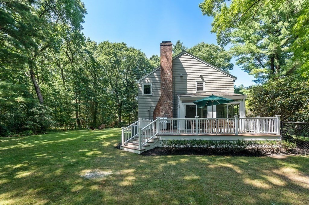 23 Colgate Road Wellesley, MA 02482 - Photo 32 of 32 a front view of a house with a yard table and chairs