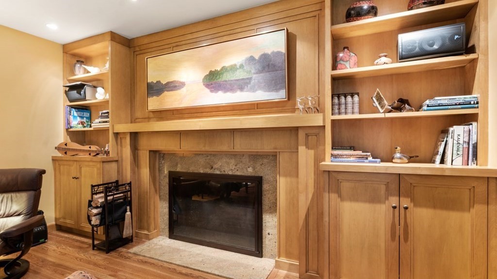 23 Colgate Road Wellesley, MA 02482 - Photo 7 of 32 a living room with a fireplace and a wooden floor