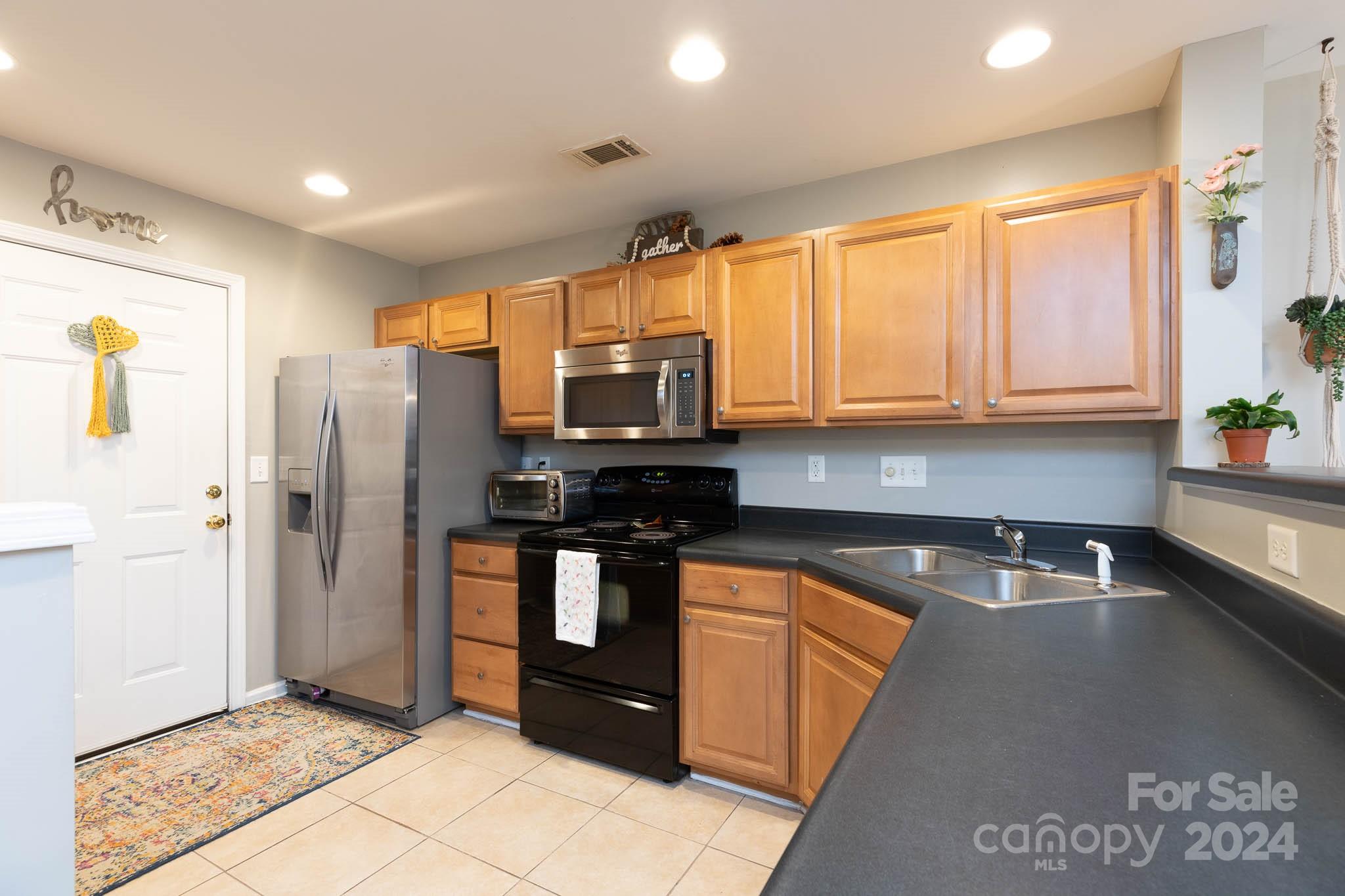 1681 Alpine Ridge Place Rock Hill, SC 29732 - Photo 6 of 20 a kitchen with stainless steel appliances granite countertop a refrigerator and a sink