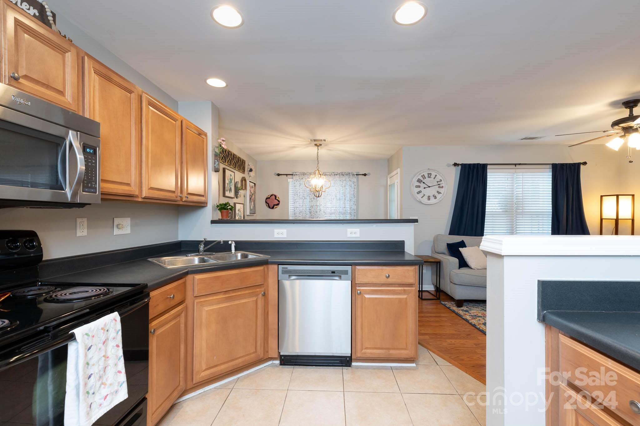 1681 Alpine Ridge Place Rock Hill, SC 29732 - Photo 7 of 20 a kitchen with stainless steel appliances granite countertop a stove a sink and a microwave