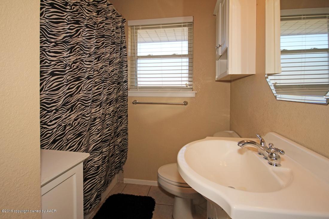 4213 Farmers Avenue Amarillo, TX 79110 - Photo 15 of 24 a bathroom with a sink a toilet and shower
