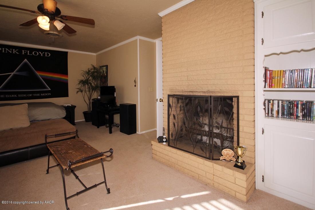 4213 Farmers Avenue Amarillo, TX 79110 - Photo 17 of 24 a living room with furniture a rug and a fireplace