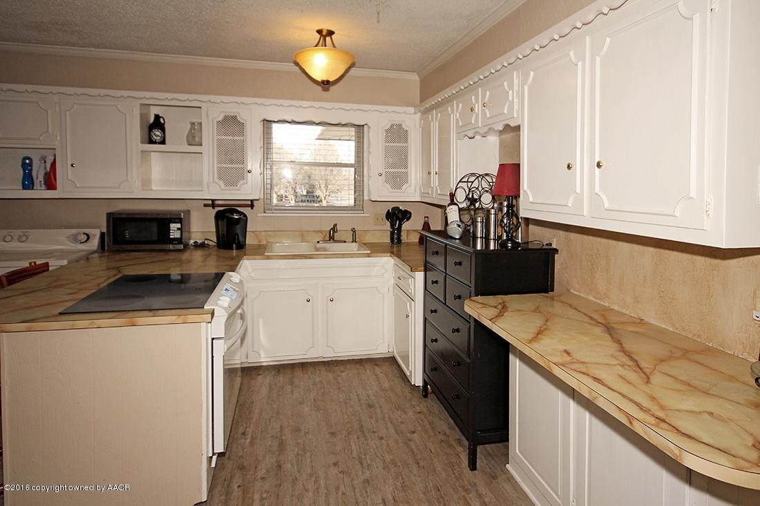 4213 Farmers Avenue Amarillo, TX 79110 - Photo 6 of 24 a kitchen that has a sink and a stove