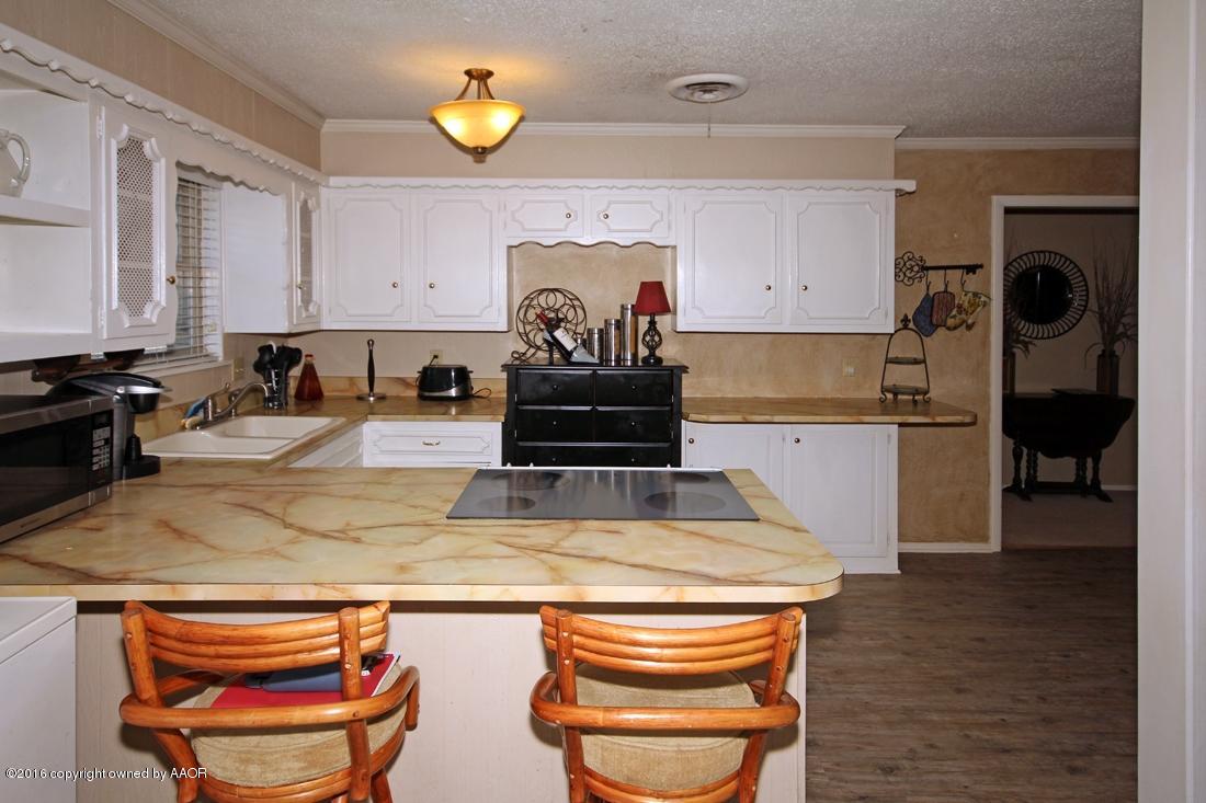 4213 Farmers Avenue Amarillo, TX 79110 - Photo 8 of 24 a kitchen with stainless steel appliances granite countertop a sink stove and cabinets