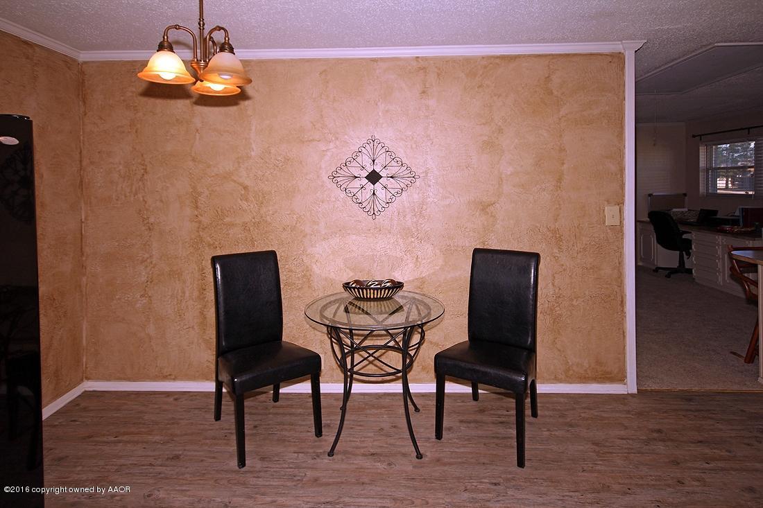 4213 Farmers Avenue Amarillo, TX 79110 - Photo 9 of 24 a dining room with furniture and wooden floor