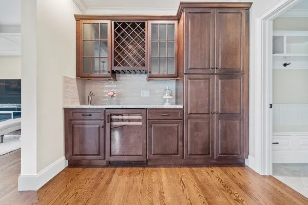 a view of a kitchen with wooden floor and cabinets