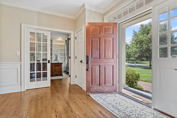 en empty room with wooden floor and windows