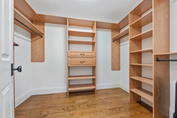 a view of walk in closet with empty racks