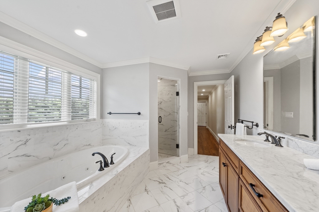 18 Victory Garden Way Lexington, MA 02420 - Photo 26 of 42 a bathroom with a granite countertop tub sink and mirror