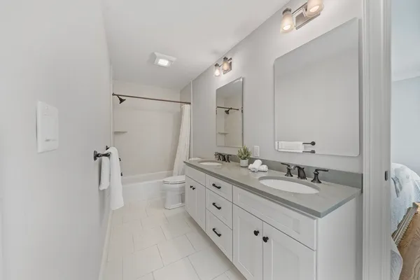 a bathroom with a double vanity sink mirror double and shower