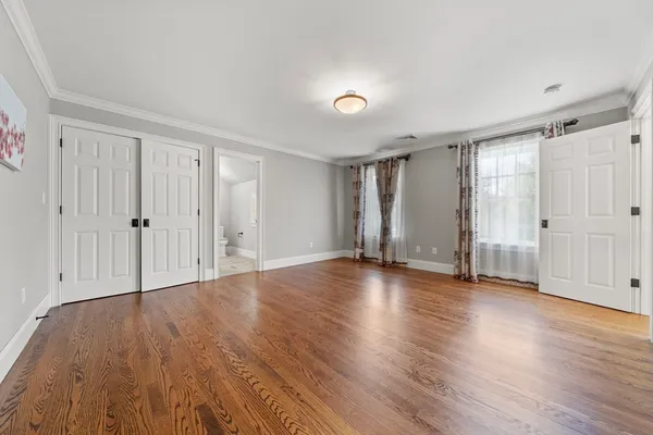 a view of empty room with wooden floor