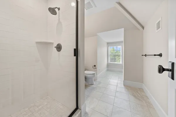 a bathroom with a shower and a toilet