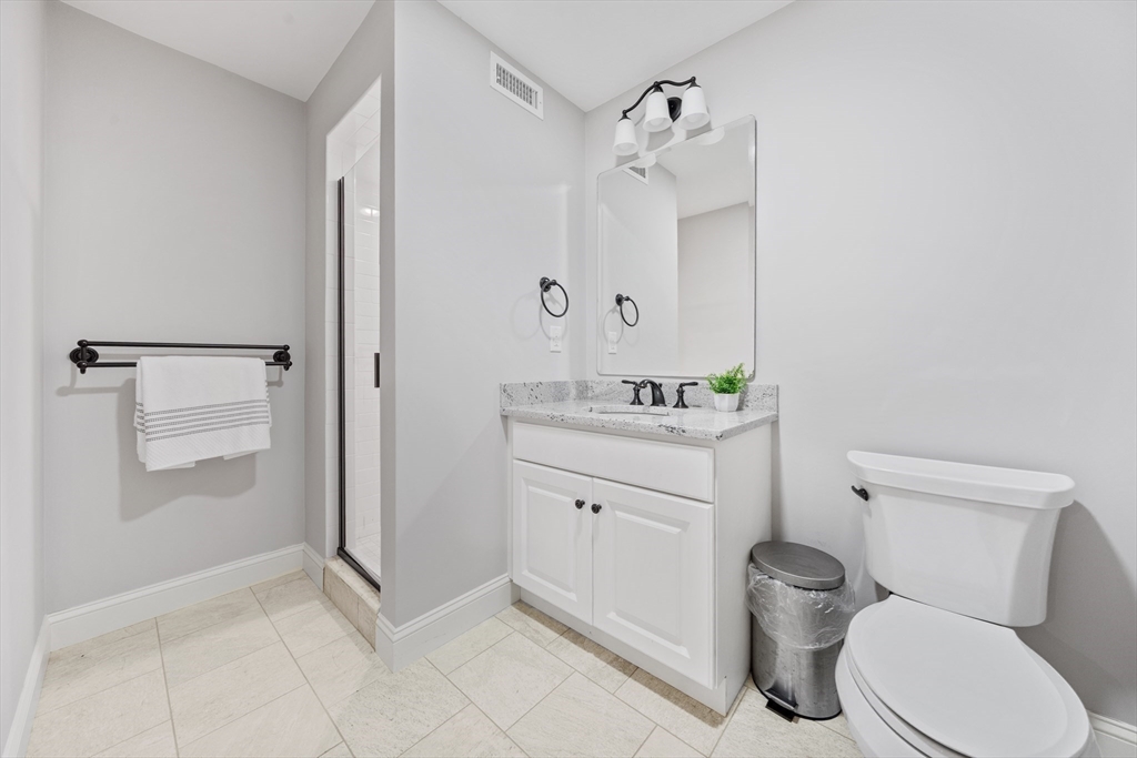 18 Victory Garden Way Lexington, MA 02420 - Photo 37 of 42 a bathroom with a toilet sink and a mirror