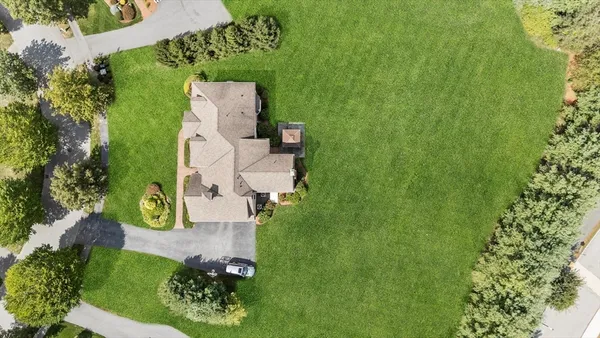 an aerial view of a house with a yard