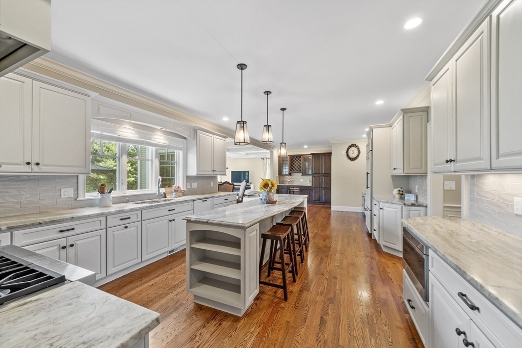 18 Victory Garden Way Lexington, MA 02420 - Photo 5 of 42 a large kitchen with cabinets wooden floor and stainless steel appliances