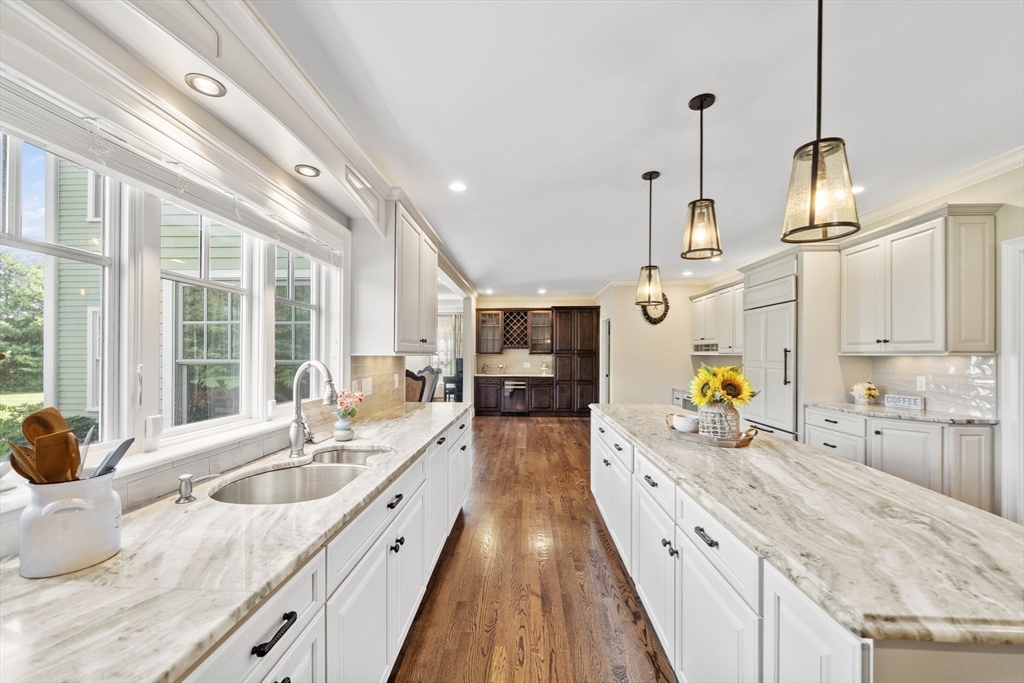 18 Victory Garden Way Lexington, MA 02420 - Photo 6 of 42 a large kitchen with stainless steel appliances kitchen island granite countertop a sink and wooden floor