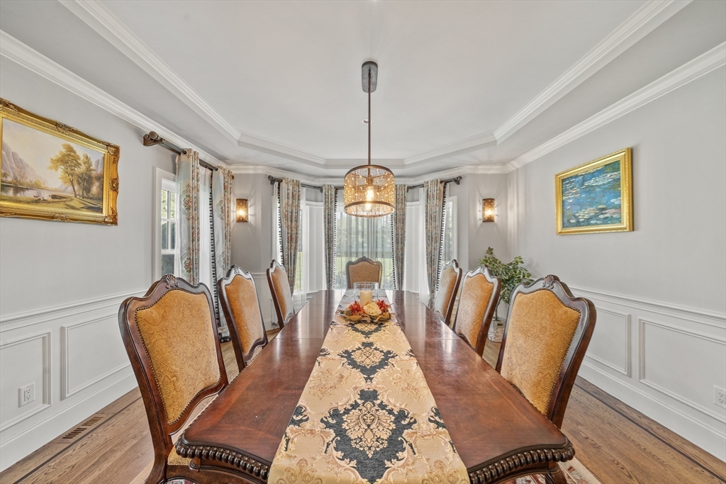 18 Victory Garden Way Lexington, MA 02420 - Photo 8 of 42 a dining room with furniture a chandelier and wooden floor