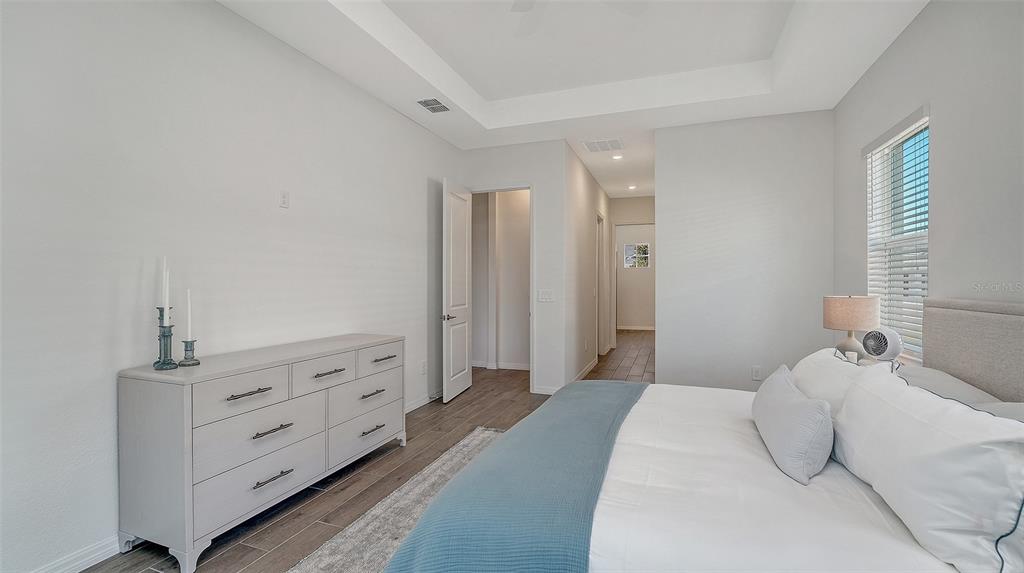 17160 Albatross Road Venice, FL 34293 - Photo 21 of 91 a bedroom with a bed and a dresser