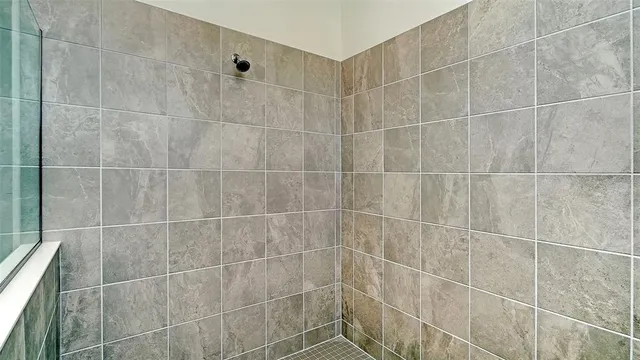 a view of an house with backyard and bushes