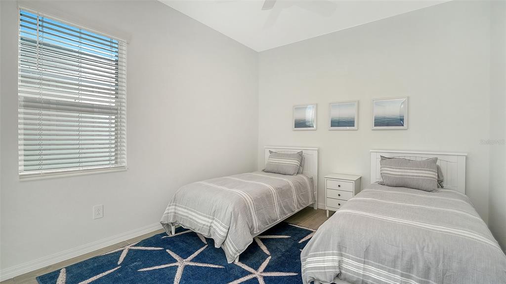 17160 Albatross Road Venice, FL 34293 - Photo 25 of 91 a bedroom with two beds and a window