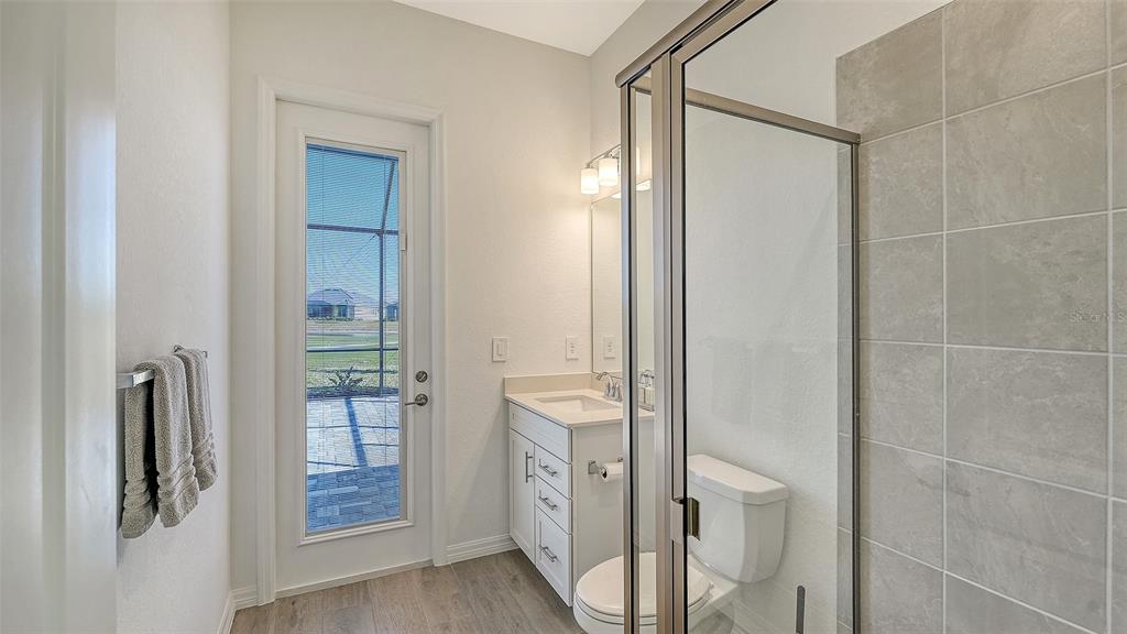 17160 Albatross Road Venice, FL 34293 - Photo 31 of 91 a bathroom with a shower and a mirror